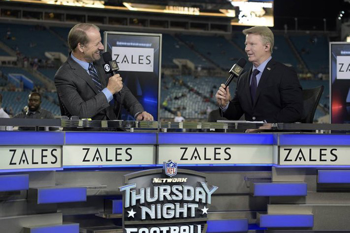  FILE - In this Nov. 19, 2015, file photo, Thursday Night Football sportscasters Bill Cowher, left, and Phil Simms broadcast from the set on the field before an NFL football game between the Jacksonville Jaguars and the Tennessee Titans in Jacksonville, Fla. Every single NFL football game will be shown online during the 2016 season for the first time, but they come with plenty of requirements and restrictions. (AP Photo/Phelan M. Ebenhack, File)