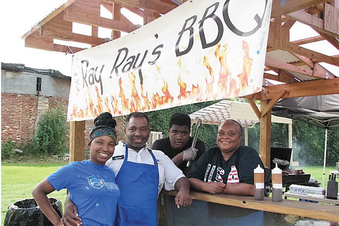 SUMMER MARKET VENDORS—Ray Ray’s BBQ is a taste of what is available during the summer market on Second Avenue. Owner Jere Woods her father Andre Woods, worker Ernest Smith and aunt Tannya Harris hanging out on a Friday afternoon. 
