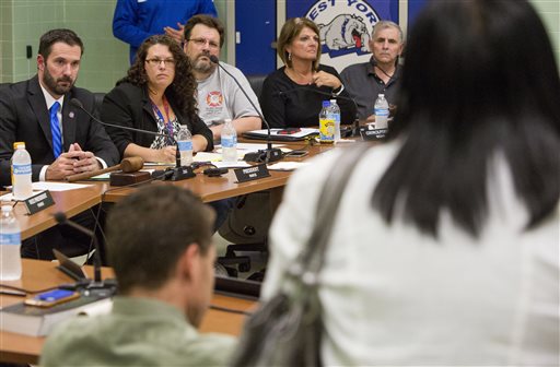 In this Monday, Oct. 3, 2016, photo West York Borough Council members listen to speakers voice their concerns about Mayor Charles Wasko, over racist posts he made on his Facebook page, at a borough council meeting in West York, Pa. PennLive.com reported the West York Council unanimously approved a motion Monday night to censure Republican Mayor Wasko. (Mark Pynes/PennLive.com via AP)