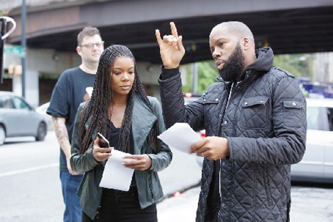 LEARNING THE SCRIPT—Actress Gabrielle Union and David E. Talbert on Set of “Almost Christmas” (Photo Courtesy of Universal Pictures/Quantrell D. Colbert)