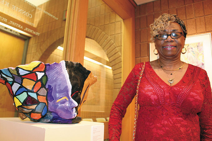 ALTHA PITTRELL, from the North Side, stands by her sculpture. 