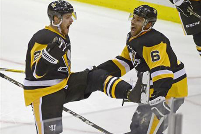 Pittsburgh Penguins left wing Scott Wilson (23) celebrates his first goal of the season with the help of defenseman Trevor Daley (6) during the third period of an NHL hockey game against the San Jose Sharks, Thursday, Oct. 20, 2016, in Pittsburgh. (AP Photo/Fred Vuich)