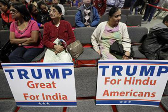 Signs are placed on seats as people wait for a charity event hosted by the Republican Hindu Coalition, Saturday, Oct. 15, 2016, in Edison, N.J. Republican presidential candidate Donald Trump spoke during the event. (AP Photo/Julio Cortez)
