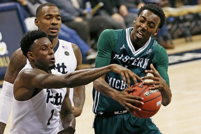 Pittsburgh forward Jamel Artis, left, blocks a shot by Eastern Michigan guard Tim Bond, right, during the second half of NCAA college basketball action in Pittsburgh, Friday, Nov. 11, 2016. (AP Photo/Gene J. Puskar)