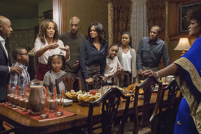 A family gathers for dinner in "Almost Christmas." (Quantrell D. Colbert/Universal Pictures via AP) 