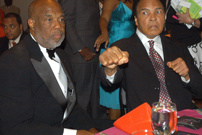 In this May 5, 2006 file photo, photographer Howard Bingham, left, and longtime friend Muhammad Ali attend a reception at the Muhammad Ali Center in Louisville, Ky. (AP Photo/Brian Bohannon, File)