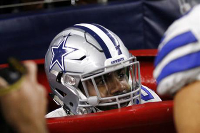 Dallas Cowboys running back Ezekiel Elliott peeks out of a large Salvation Army kettle after jumping into it celebrating a touchdown he scored on a running play in the first half of an NFL football game against the Tampa Bay Buccaneers on Sunday, Dec. 18, 2016, in Arlington, Texas. (AP Photo/Roger Steinman) Dallas Cowboys running back Ezekiel Elliott peeks out of a large Salvation Army kettle after jumping into it celebrating a touchdown he scored on a running play in the first half of an NFL football game against the Tampa Bay Buccaneers on Sunday, Dec. 18, 2016, in Arlington, Texas. (AP Photo/Roger Steinman)
