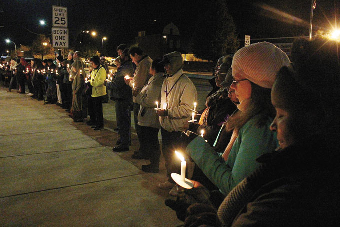 LIT CANDLES—Many people lined up along the sidewalk, from one corner to the next, with their candles lit. (Photos by J. L. Martello) 