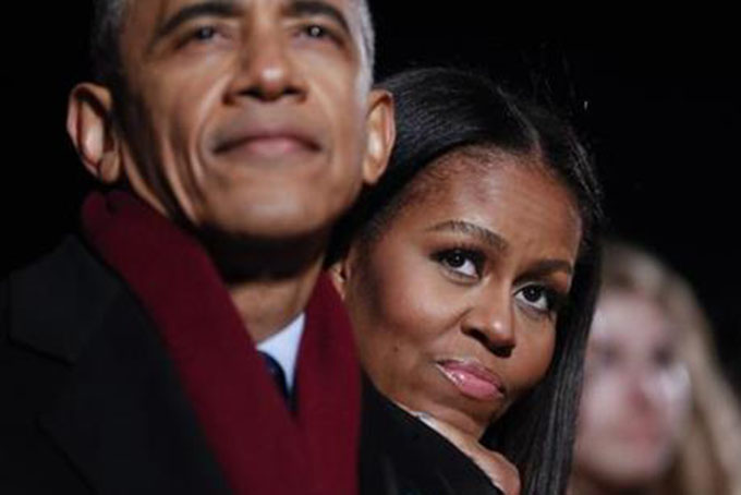 In this Dec. 1, 2016 photo, first lady Michelle Obama and President Barack Obama watch musical performances at the 2016 National Christmas Tree lighting ceremony near the White House. (AP Photo/Pablo Martinez Monsivais)