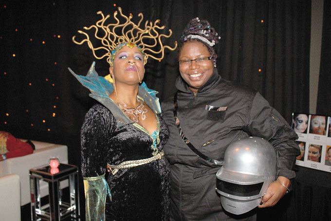 SPACE ODYSSEY—Jasmine Burnett, left, and La'Tasha Mayes of New Voices Pittsburgh pose at its Black to the Future 12th Anniversary Gala at WQED studios, Dec. 3. (Photo by J.L. Martello)