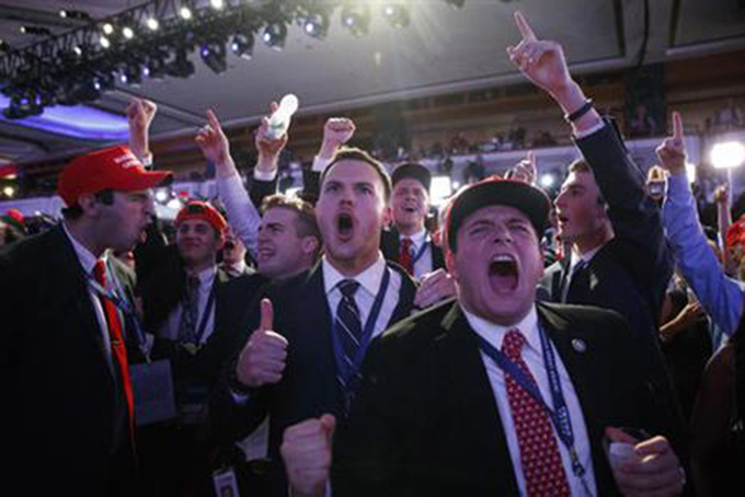 FILE - In this Nov. 9, 2016 file photo, supporters of President-elect Donald Trump cheer during as they watch election returns during an election night rally in New York. Among the youngest white adult Americans, feelings of racial and economic vulnerability appear to be closely connected to their support for Donald Trump in last month’s election. (AP Photo/ Evan Vucci, File)
