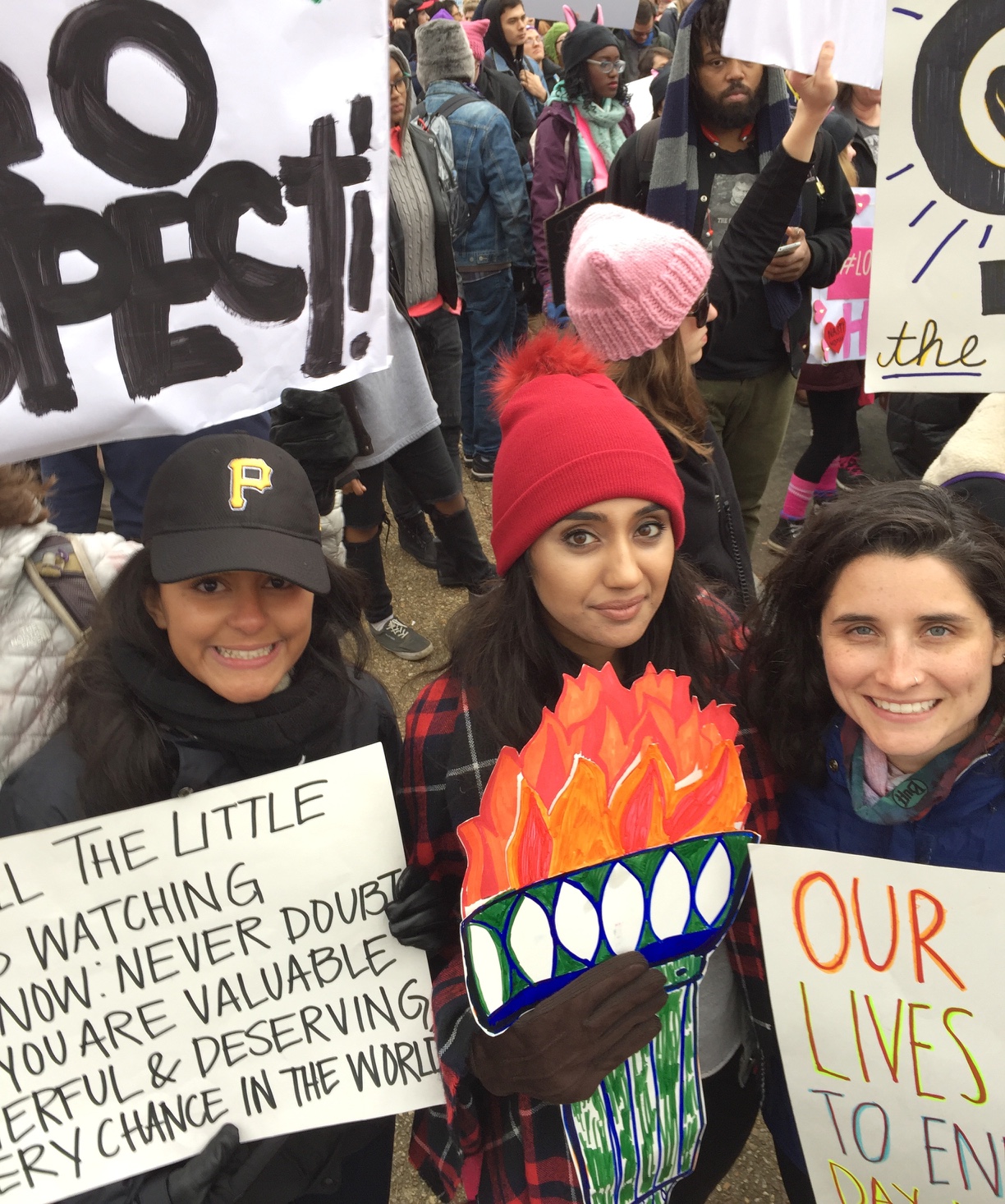 These Pittsburgh women marched in the Women’s March on Washington. From left: Amy Lind, 24, who lives in Shadyside; Amber Chaudhry, 24, also lives in Shadyside and Elisa Portillo, 25, if from Squirrel Hill. (Photo by Martha Rial/PublicSource)