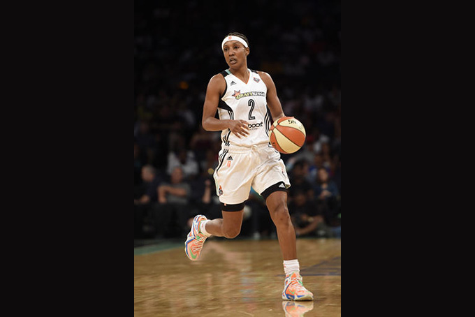 In this July 16, 2015, file photo, New York Liberty guard Candice Wiggins brings the ball up during the team's WNBA basketball game against the Connecticut Sun in New York. Wiggins said her experience playing in the WNBA was "toxic" and was a major reason why she retired last season. In an interview with The San Diego Union-Tribune, Wiggins said the culture in the league was "very, very harmful" and that she was targeted throughout her career for being heterosexual and popular. (AP Photo/Kathy Kmonicek, File)