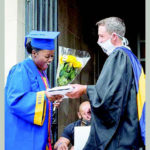 STEPHAN SEREDA, the new Westinghouse High School principal, hands a Westinghouse student her diploma.
