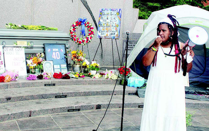 DANNIELLE BROWN addresses the crowd at her “Living Funeral” at Freedom Corner, Aug. 6.