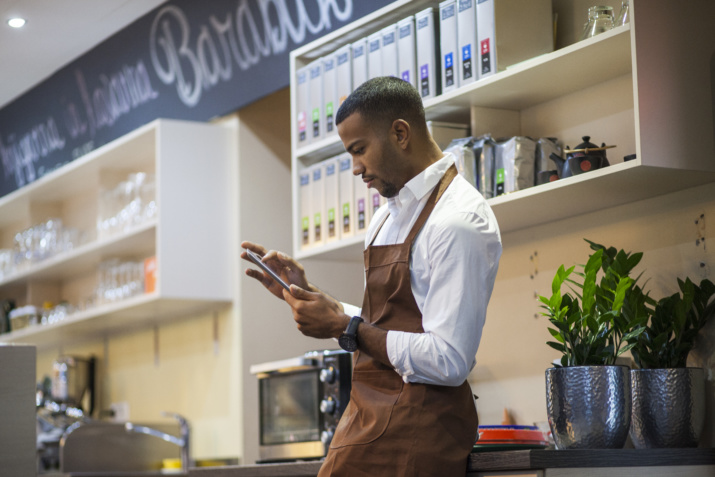 Young bar owner with digital tablet