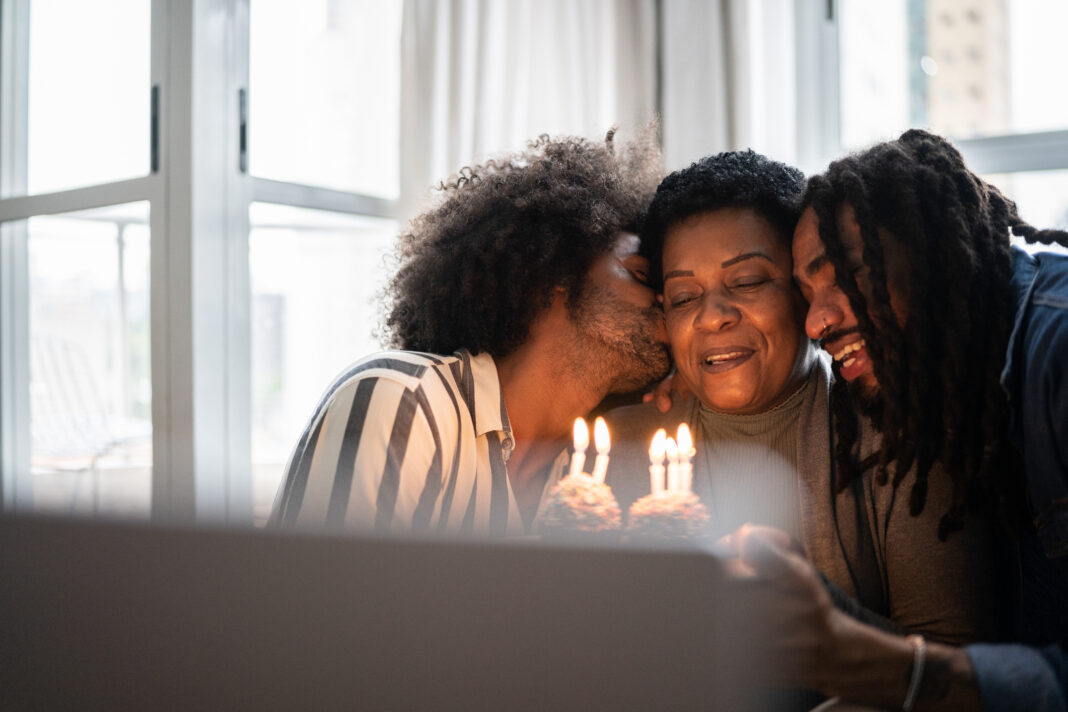 Family celebrating mother's birthday on a video call at home