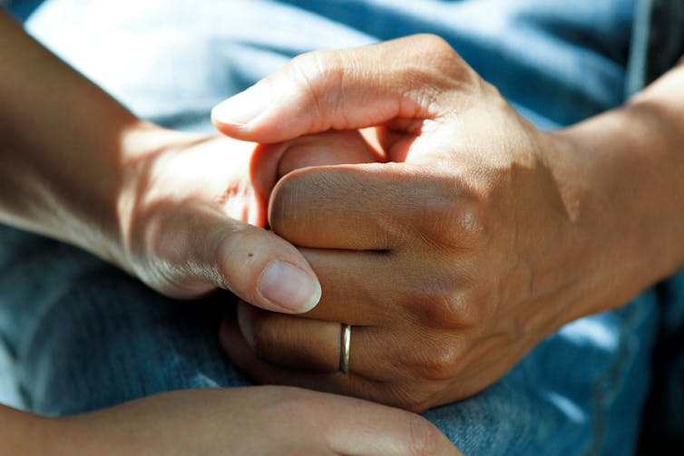Clasping hands.