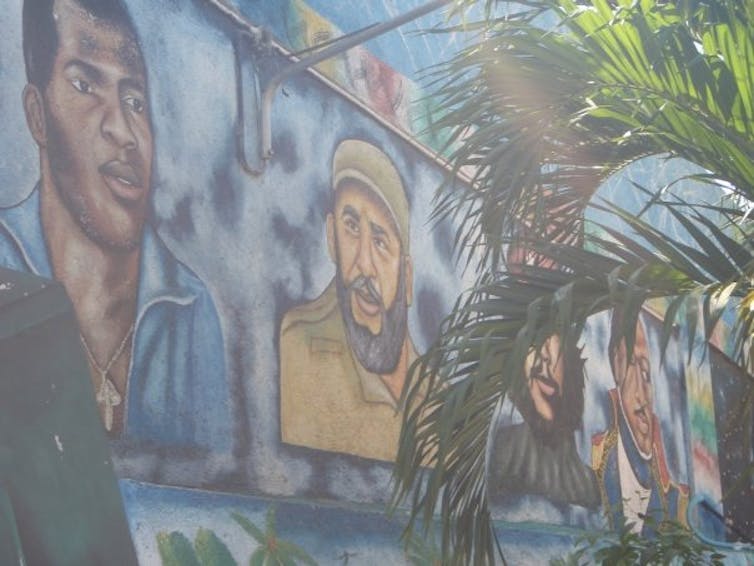 A large mural shows people's faces.